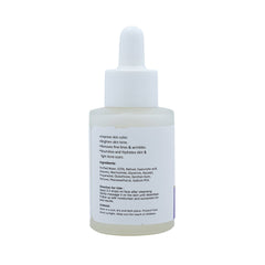 Close-up of Rejumax serum bottle with detailed label, on white surface with green leaves, highlighting skincare ingredients